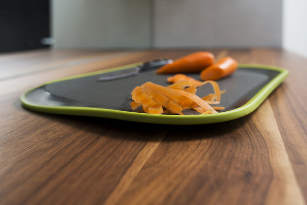 Tilt - angled non-slip chopping board