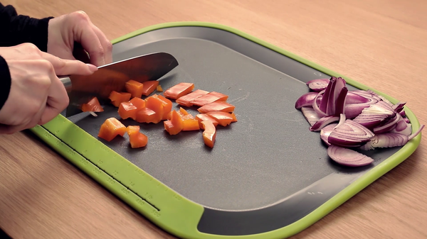 Tilt - angled non-slip chopping board